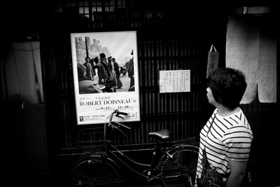 In striped shirt woman standing next to the bike grayscale images
